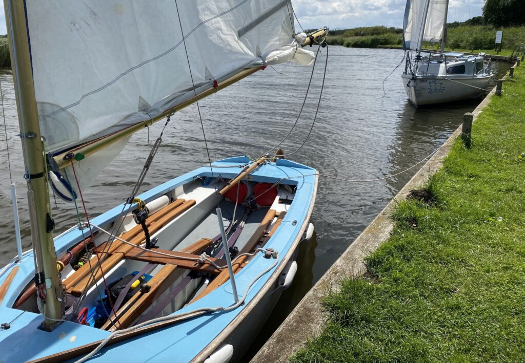 Dinghy and yacht tied up alongside a wharf