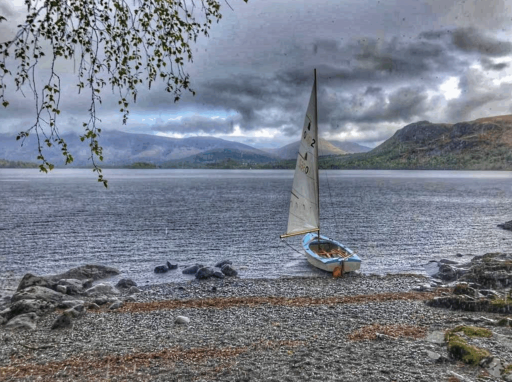 A boat on the shore in a torrential rainstorm.