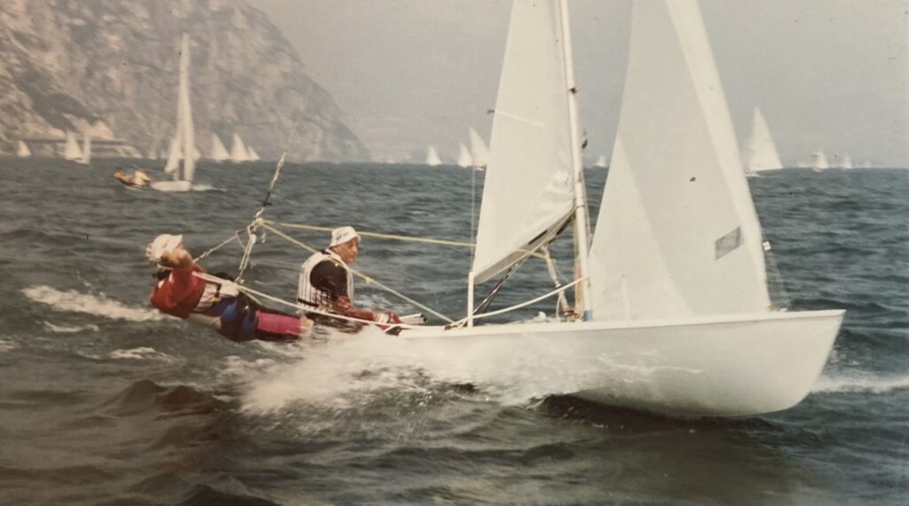 A sailing dinghy being sailed in high winds on a European lake