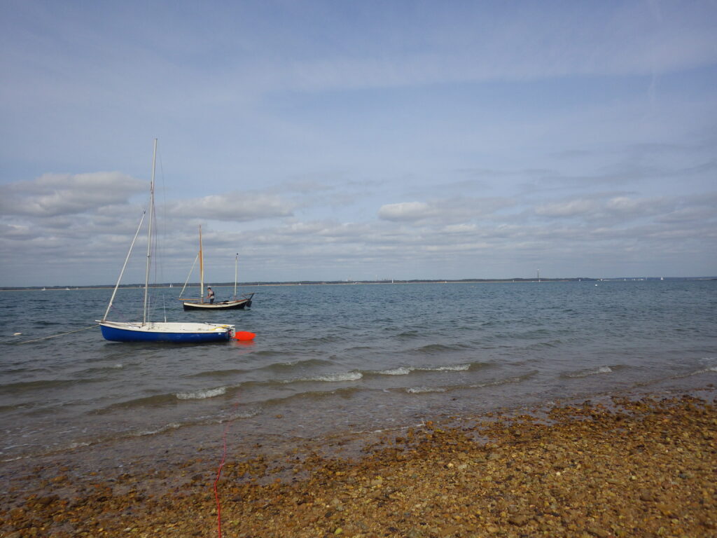Gurnard Ledge Beach with two dinghies in the foreground.